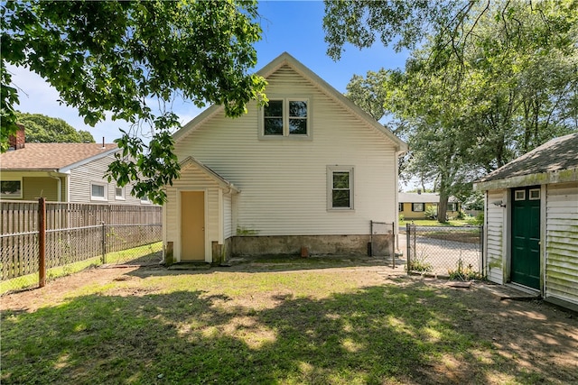 35 Inman Ave, Warwick, RI 02886 - back of house with a storage unit, a fenced backyard, and a gate