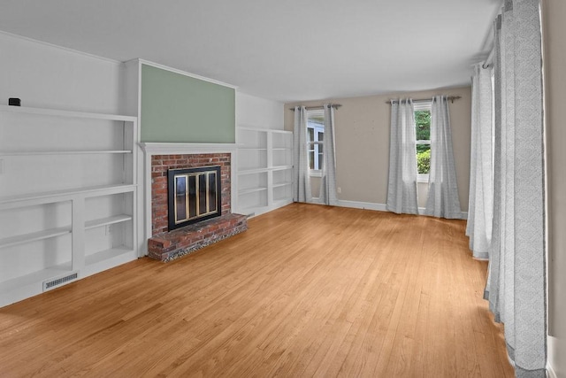22 Oakridge Rd, Scituate, RI 02857 - unfurnished living room with wood finished floors, built in features, and a fireplace