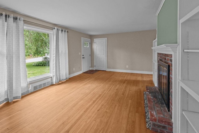 22 Oakridge Rd, Scituate, RI 02857 - unfurnished living room with wood finished floors and a brick fireplace