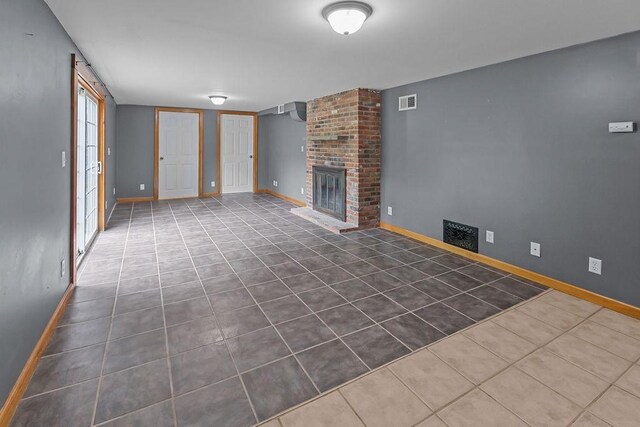 22 Oakridge Rd, Scituate, RI 02857 - unfurnished living room featuring dark tile patterned flooring and a brick fireplace
