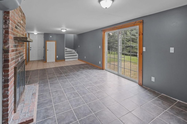 22 Oakridge Rd, Scituate, RI 02857 - unfurnished living room with tile patterned flooring, stairs, and a brick fireplace