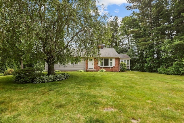 22 Oakridge Rd, Scituate, RI 02857 - view of front facade featuring a chimney, a front yard, and brick siding