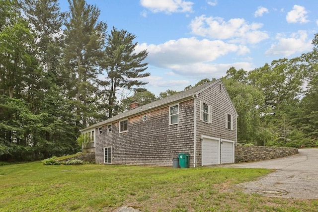 22 Oakridge Rd, Scituate, RI 02857 - view of home's exterior featuring a garage, a chimney, asphalt driveway, and a lawn