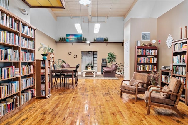1 Tupperware Dr Unit 115, North Smithfield, RI 02896 - sitting room with bookshelves and hardwood / wood-style flooring