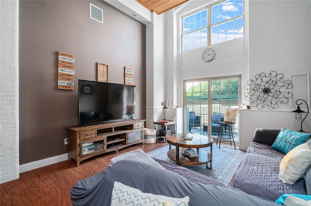 1 Tupperware Dr Unit 115, North Smithfield, RI 02896 - living room featuring wood finished floors, a high ceiling, and wainscoting