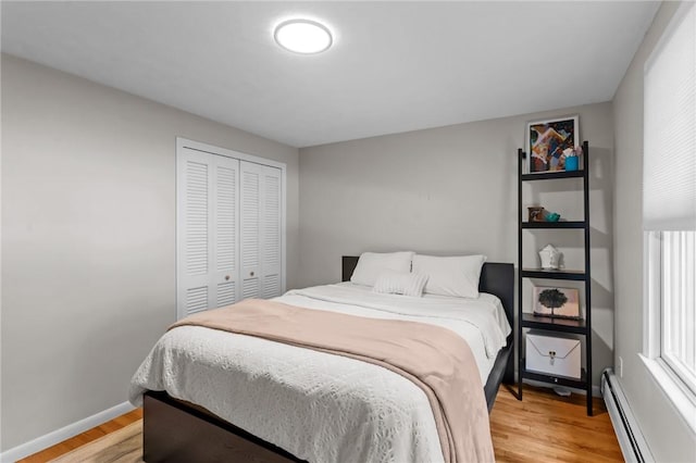 55 Atherton Rd, East Greenwich, RI 02818 - bedroom with a baseboard radiator, light wood-style flooring, and a closet