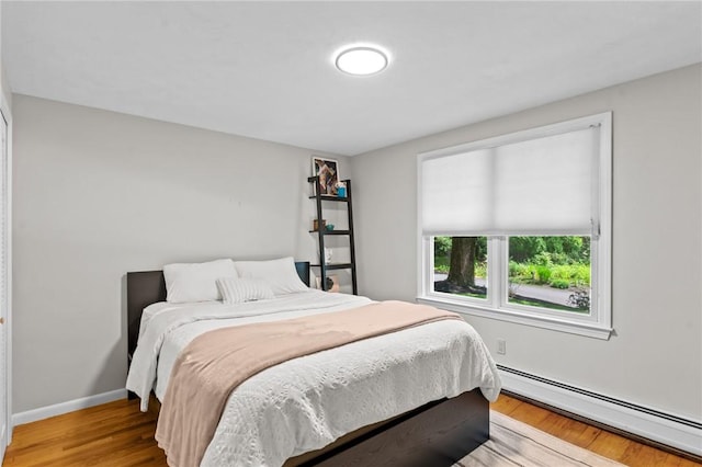 55 Atherton Rd, East Greenwich, RI 02818 - bedroom with a baseboard radiator and wood finished floors