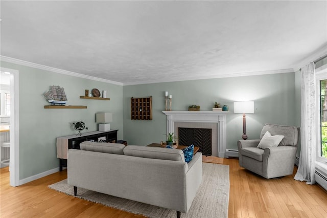 55 Atherton Rd, East Greenwich, RI 02818 - living area featuring baseboard heating, light wood-type flooring, ornamental molding, and a tile fireplace