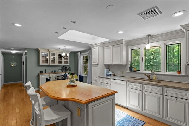 55 Atherton Rd, East Greenwich, RI 02818 - kitchen featuring dishwasher, a kitchen island, decorative light fixtures, light wood finished floors, and recessed lighting