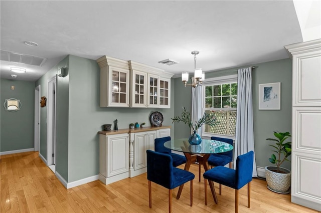 55 Atherton Rd, East Greenwich, RI 02818 - dining room featuring a chandelier, light wood finished floors, and baseboard heating
