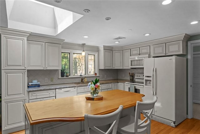 55 Atherton Rd, East Greenwich, RI 02818 - kitchen featuring white appliances, light wood finished floors, decorative backsplash, recessed lighting, and decorative light fixtures