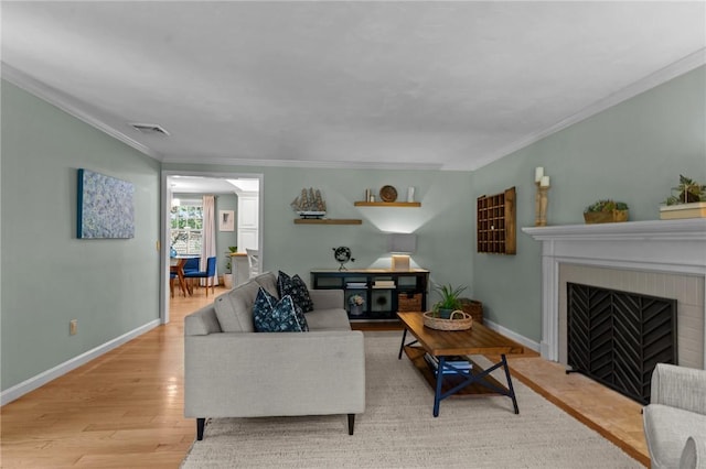 55 Atherton Rd, East Greenwich, RI 02818 - living room featuring light wood finished floors, ornamental molding, and a fireplace with flush hearth