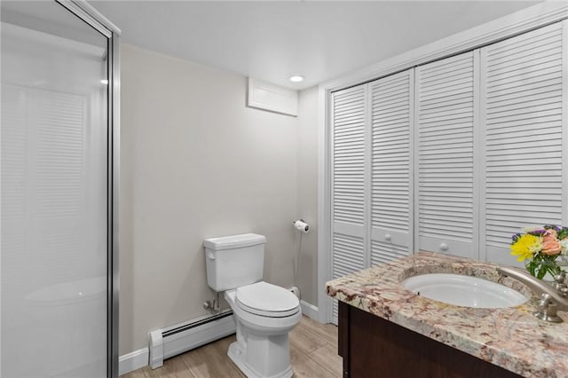 55 Atherton Rd, East Greenwich, RI 02818 - full bathroom featuring a baseboard heating unit, a closet, wood finished floors, vanity, and a shower