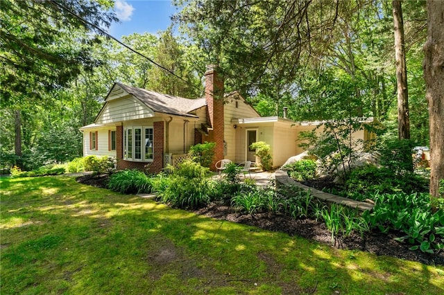 55 Atherton Rd, East Greenwich, RI 02818 - view of front of house featuring brick siding, a front lawn, and a chimney