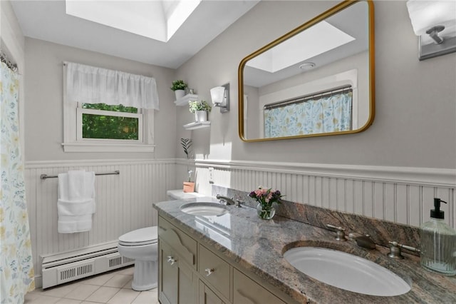 55 Atherton Rd, East Greenwich, RI 02818 - bathroom with a baseboard radiator, a wainscoted wall, double vanity, tile patterned flooring, and a shower with curtain