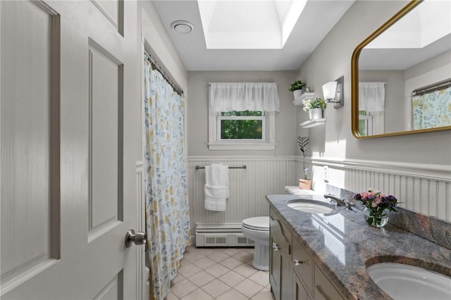 55 Atherton Rd, East Greenwich, RI 02818 - full bath with tile patterned floors, a wainscoted wall, double vanity, a skylight, and a shower with curtain