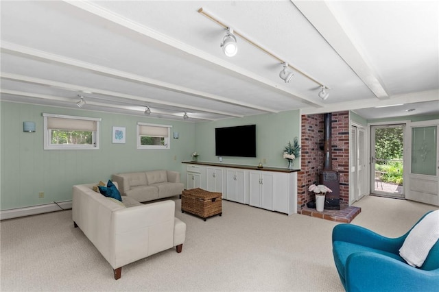55 Atherton Rd, East Greenwich, RI 02818 - carpeted living room featuring baseboard heating, a wood stove, beam ceiling, plenty of natural light, and track lighting
