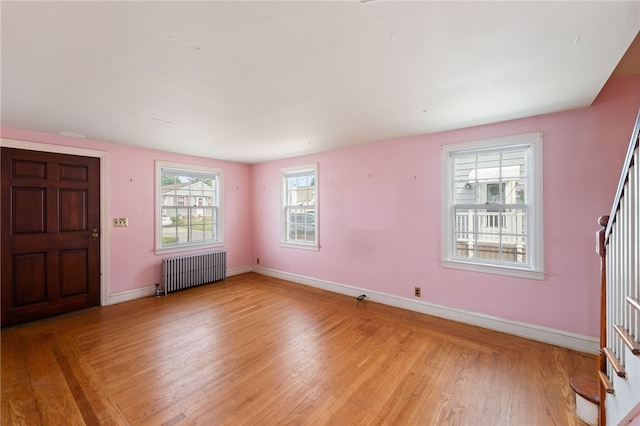 53 Overland Ave, Cranston, RI 02910 - entrance foyer featuring radiator heating unit, light wood-style flooring, and stairs