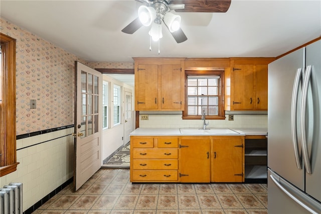 53 Overland Ave, Cranston, RI 02910 - kitchen with freestanding refrigerator, radiator heating unit, ceiling fan, light countertops, and wallpapered walls