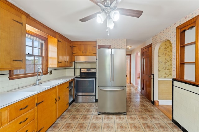 53 Overland Ave, Cranston, RI 02910 - kitchen featuring stainless steel appliances, wallpapered walls, under cabinet range hood, a ceiling fan, and light countertops