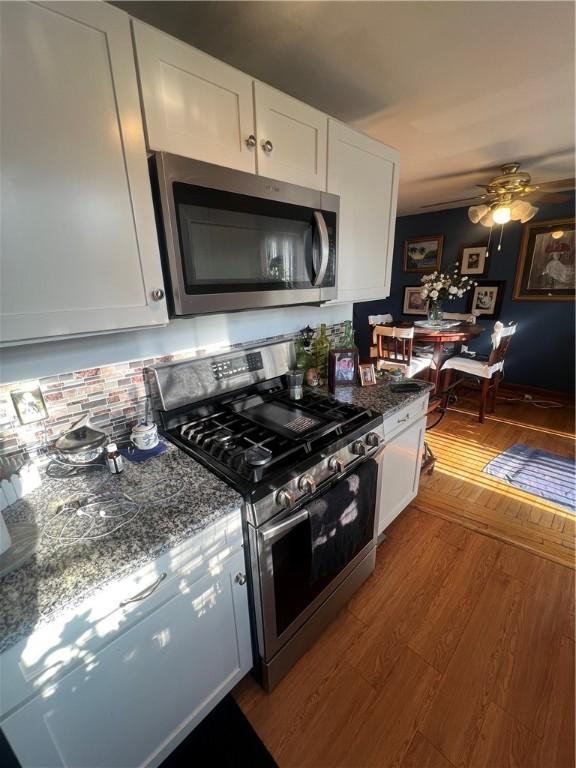 64 Kristee Cir Unit 64, West Warwick, RI 02893 - kitchen featuring appliances with stainless steel finishes, wood finished floors, white cabinets, and ceiling fan