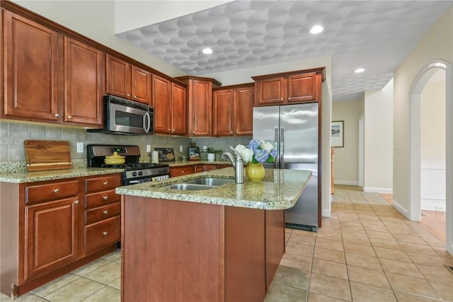 99 Preservation Way S, Kingstown, RI 02879 - kitchen featuring appliances with stainless steel finishes, tasteful backsplash, light stone countertops, and light tile patterned flooring
