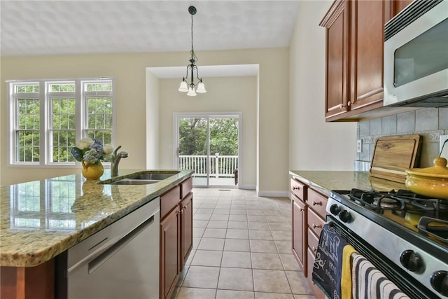 99 Preservation Way S, Kingstown, RI 02879 - kitchen with appliances with stainless steel finishes, light tile patterned floors, decorative backsplash, pendant lighting, and light stone counters