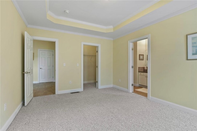 99 Preservation Way S, Kingstown, RI 02879 - unfurnished bedroom with carpet flooring, a raised ceiling, ornamental molding, a walk in closet, and ensuite bathroom