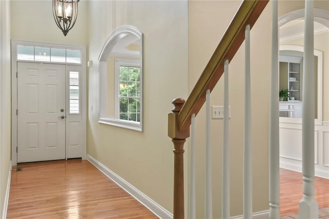 99 Preservation Way S, Kingstown, RI 02879 - entrance foyer featuring light wood-type flooring, arched walkways, a chandelier, and stairs