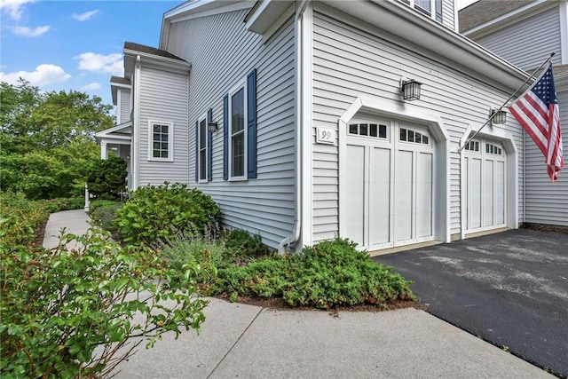99 Preservation Way S, Kingstown, RI 02879 - view of side of home featuring a garage and asphalt driveway