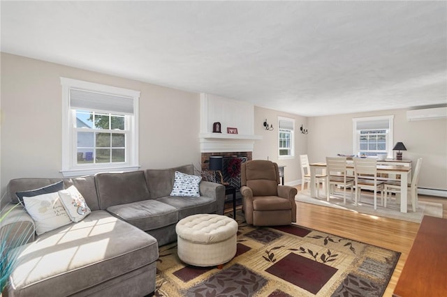 1 Adelaide Ave, Bristol, RI 02809 - living area with a wall mounted air conditioner, wood finished floors, and a fireplace