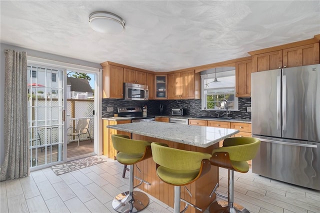 1 Adelaide Ave, Bristol, RI 02809 - kitchen featuring appliances with stainless steel finishes, plenty of natural light, and decorative backsplash