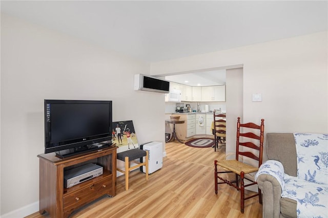 1 Adelaide Ave, Bristol, RI 02809 - living room featuring light wood-type flooring and a wall mounted air conditioner