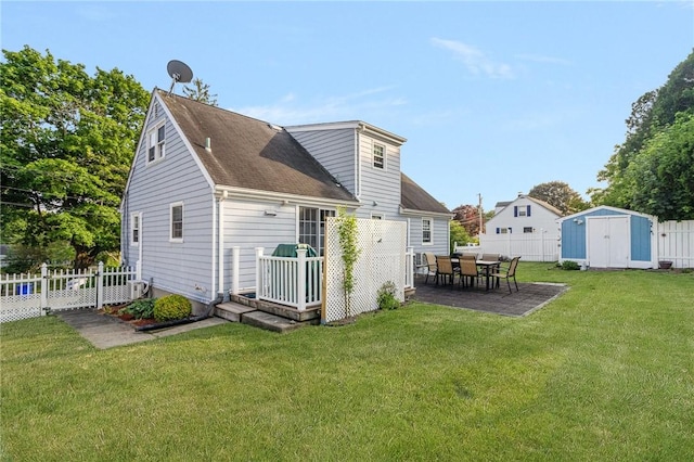 1 Adelaide Ave, Bristol, RI 02809 - back of property featuring a shed, a fenced backyard, a patio, and roof with shingles