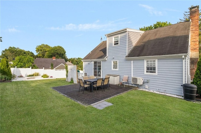 1 Adelaide Ave, Bristol, RI 02809 - back of property with a chimney, roof with shingles, and a patio area