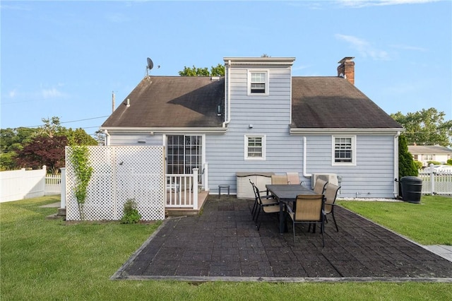 1 Adelaide Ave, Bristol, RI 02809 - back of property featuring a patio area, a chimney, and a shingled roof