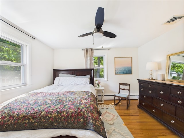 65 Bayberry Ln, East Greenwich, RI 02818 - bedroom with a baseboard radiator, light wood finished floors, and a ceiling fan
