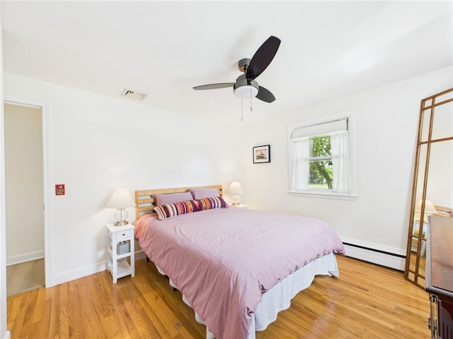 65 Bayberry Ln, East Greenwich, RI 02818 - bedroom featuring baseboard heating, light wood-style flooring, and ceiling fan