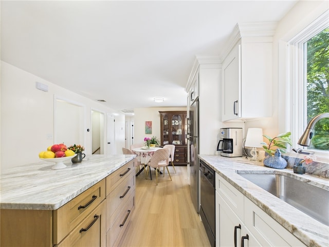 65 Bayberry Ln, East Greenwich, RI 02818 - kitchen with light wood-style flooring, light stone countertops, white cabinetry, and dishwashing machine