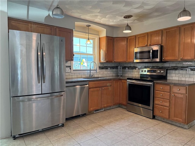17 Chester Ave, Warwick, RI 02889 - kitchen with appliances with stainless steel finishes, brown cabinets, tasteful backsplash, and hanging light fixtures