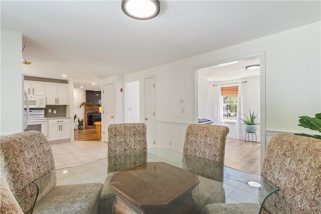 6 Fleuette Dr, Bellingham, MA 02019 - dining room featuring light tile patterned flooring and a brick fireplace