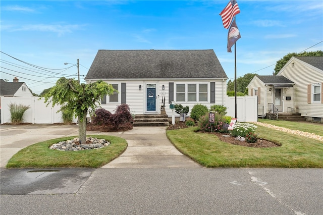 32 Waterman Ave, Johnston, RI 02919 - cape cod-style house with concrete driveway, a gate, and a shingled roof