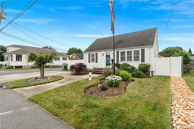 32 Waterman Ave, Johnston, RI 02919 - cape cod home featuring a shingled roof and a gate