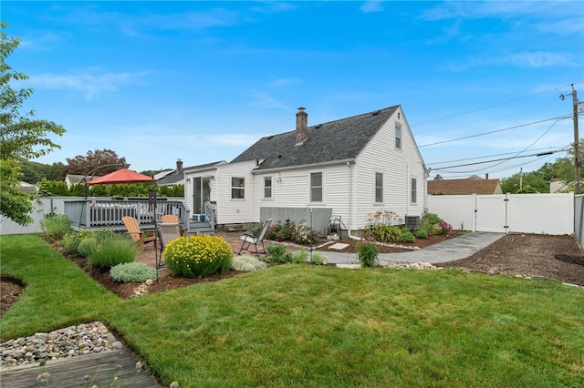 32 Waterman Ave, Johnston, RI 02919 - back of house featuring a gate, a fenced backyard, a patio area, a chimney, and roof with shingles