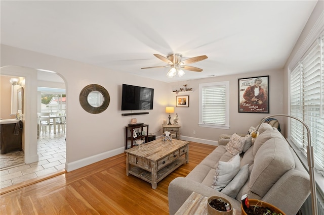 32 Waterman Ave, Johnston, RI 02919 - living area featuring arched walkways, ceiling fan, and light wood-style flooring