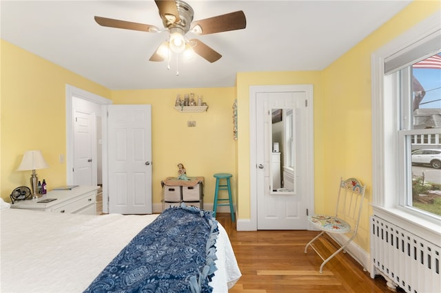 32 Waterman Ave, Johnston, RI 02919 - bedroom with radiator heating unit, light wood-style floors, multiple windows, and ceiling fan