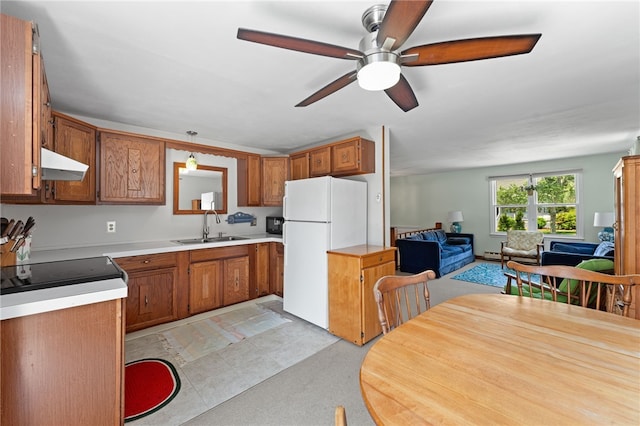 143 Juniper Rd, South Kingstown, RI 02879 - kitchen with freestanding refrigerator, under cabinet range hood, and brown cabinetry