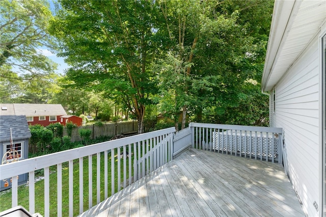 143 Juniper Rd, South Kingstown, RI 02879 - deck featuring a storage unit and view of wooded area