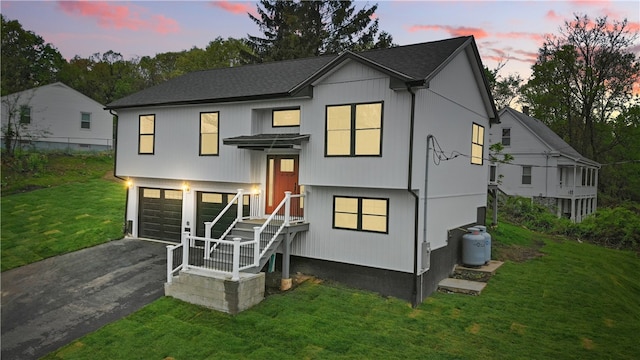 50 Rosemont Ave, Johnston, RI 02919 - view of front of house featuring driveway, a garage, a yard, and roof with shingles
