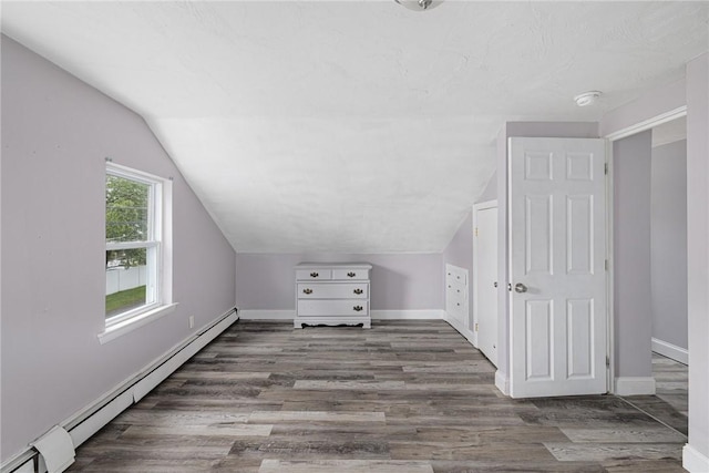 100 Pine Grove St, East Providence, RI 02916 - additional living space with a baseboard heating unit, vaulted ceiling, and wood finished floors